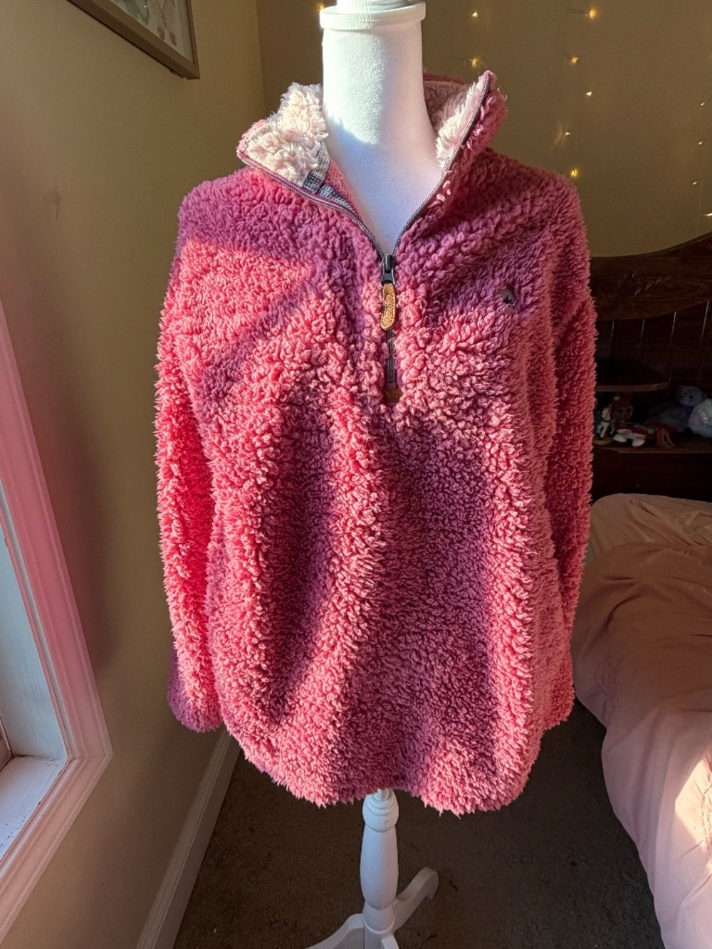 This ultra-soft pink/mauve textured sherpa quarter-zip fleece